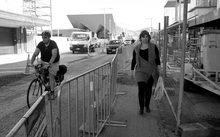 A black and white image of people walking on a Christchurch Road
