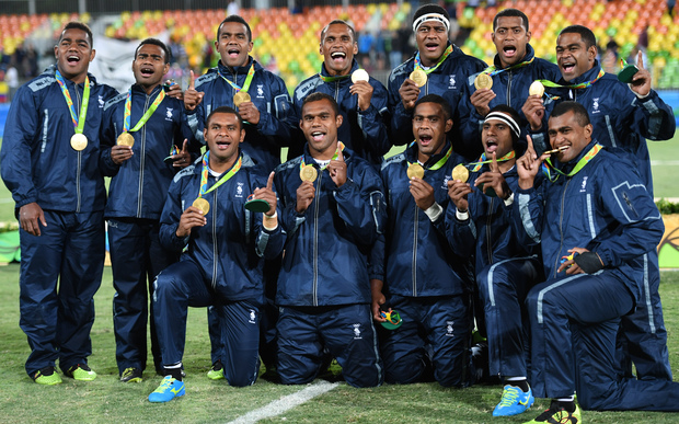 Gold medallists Fiji celebrate during the men’s rugby sevens medal ceremony during the Rio 2016 Olympic Games at Deodoro Stadium in Rio de Janeiro onAugust 11, 2016. 