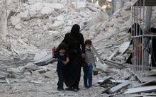 A Syrian family following a reported airstrike on the  al-Muasalat area in the northern Syrian city of Aleppo. 