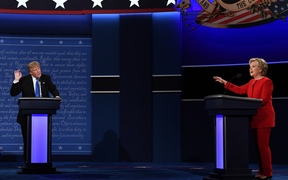 Republican presidential nominee Donald Trump, left, speaks as Democratic presidential nominee Hillary Clinton gestures at the debate at Hofstra University in Hempstead, New York. 