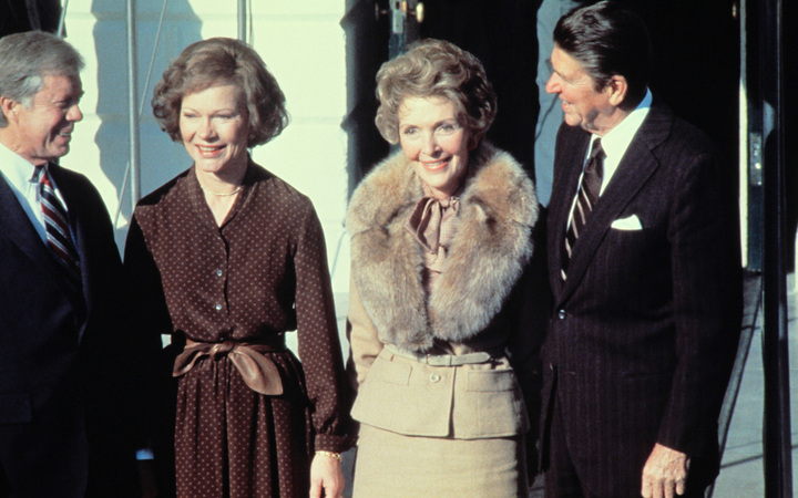 Jimmy Carter, left, Rosalynn Carter, second left, greet Ronald Reagan and his wife Nancy Reagan at the White House on 20 November 1980. 