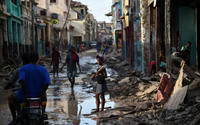 A girl walks on a street damaged in Hurricane Matthew, in Jeremie, western Haiti