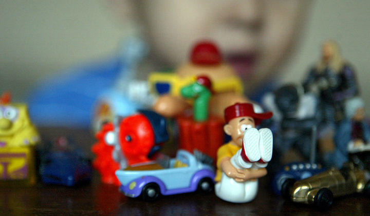 A child plays with small toys collected from the famous Kinder suprise-filled chocolate eggs by Italian confectioner Ferrero in Berlin 15 April 2004.