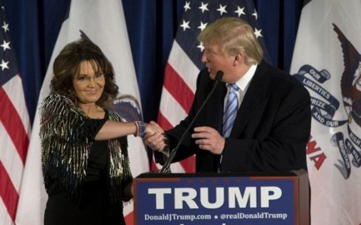 Donald Trump shakes hands with Sarah Palin at Iowa State University on January 19, 2016 in Ames, IA. Trump received Palin's endorsement at the event. Aaron P. Bernstein/Getty Images/AFP