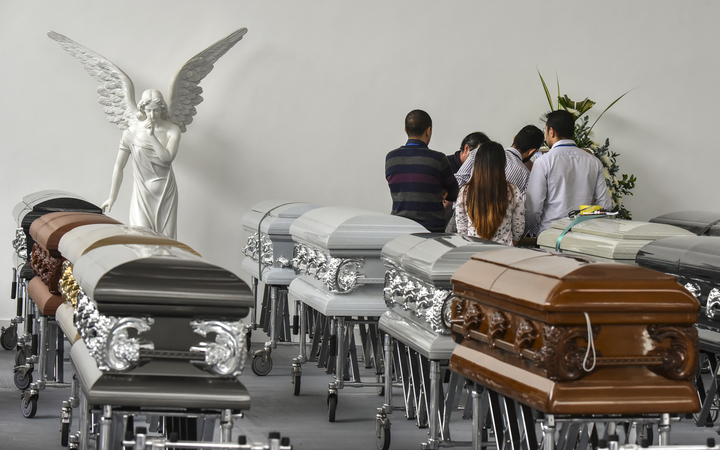 Executives of Chapecoense Real gather around the coffin of one of the team's players killed in plane crash in Colombia.