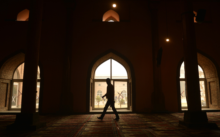 Kashmiri muslim walks by a window during the Friday prayer in Jamia Masjid in downtown Srinagar on November 25, 2016.
TAUSEEF MUSTAFA / AFP