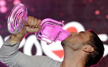 Sweden's Mans Zelmerlow holds the throphy after winning the Eurovision Song Contest.