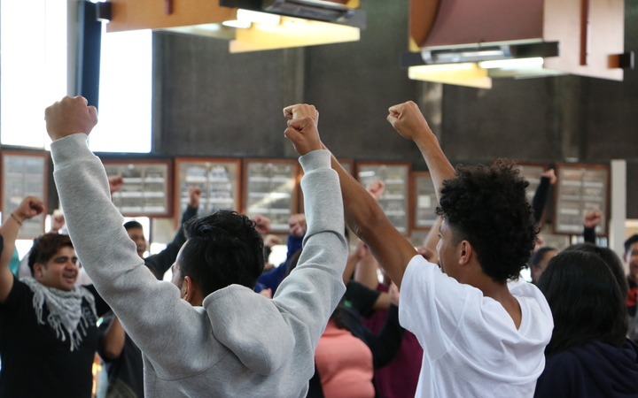 Pacific youth in Christchurch take part in a warm up game of rock, paper, scissors before question time at the Pacific Youth Parliament simulation. 