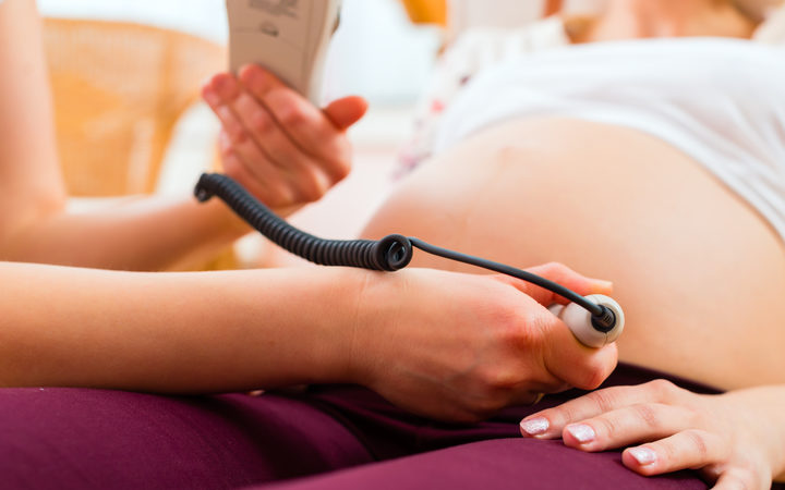 A file photo shows a midwife with a pregnant woman. 