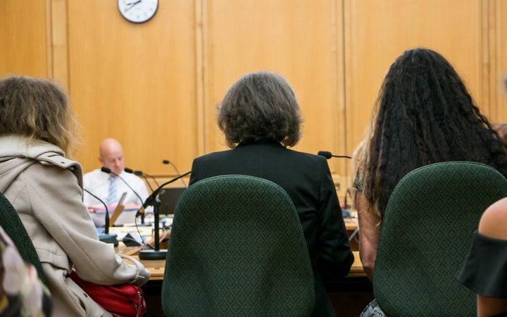 Maggie Wilkinson (center) gives her submission to Parliament on her petition calling for an inquiry into forced adoption in New Zealand between the 1950s and 1980s with her daughters either side. 
 