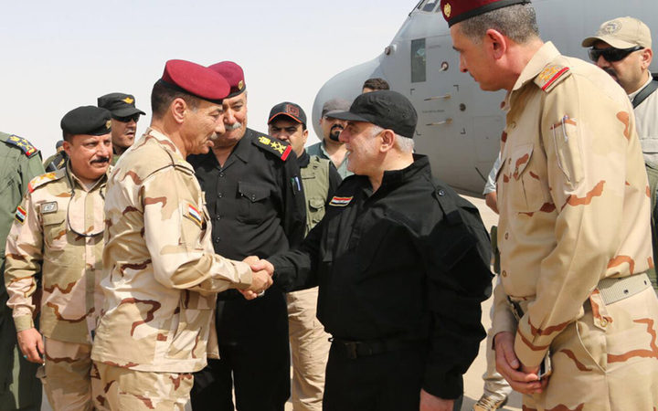  Iraqi Prime Minister Haider al-Abadi (C-R) shaking hands with army officers upon his arrival in Mosul