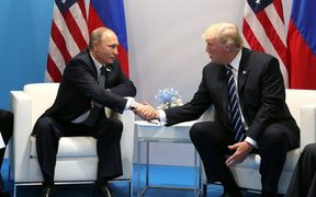 Russia's President Vladimir Putin and US President Donald Trump shake hands during a bilateral meeting on the sidelines of the G20 summit.

