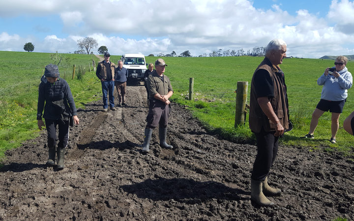 Kaumatua Pita Cherrington offers a karakia before hapū members head down to their old eeling reserve thru muddy pasture.
