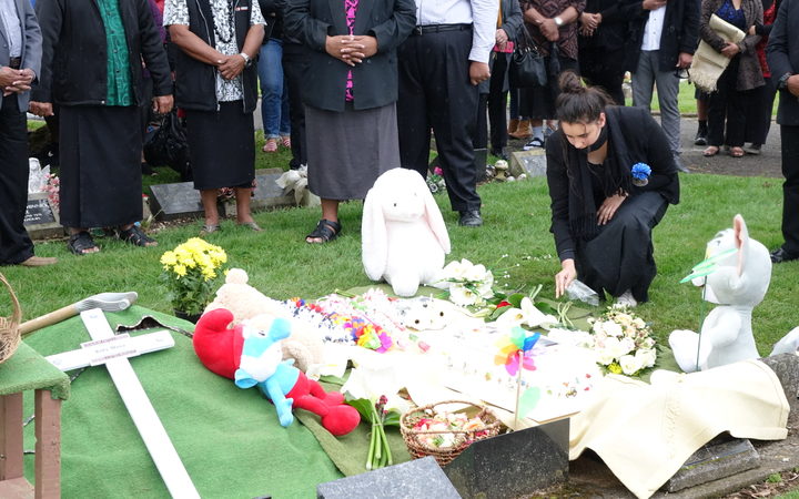Flowers are placed on Mona's grave