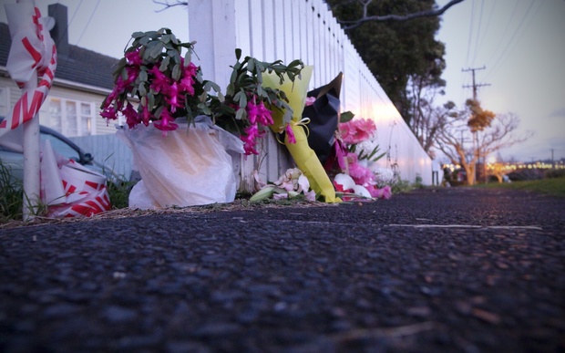 Police cordons and flowers on Tuesday at the house in Onehunga where Maggie Renee Watson was found.