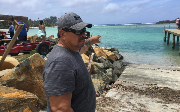 Cook Islands MP Tamaiva Tuavera points to where he rescued the three girls 