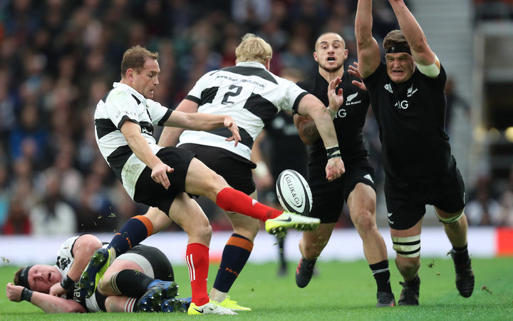 New Zealand All Blacks Scott Barrett tries to block down Barbarians Andy Ellis