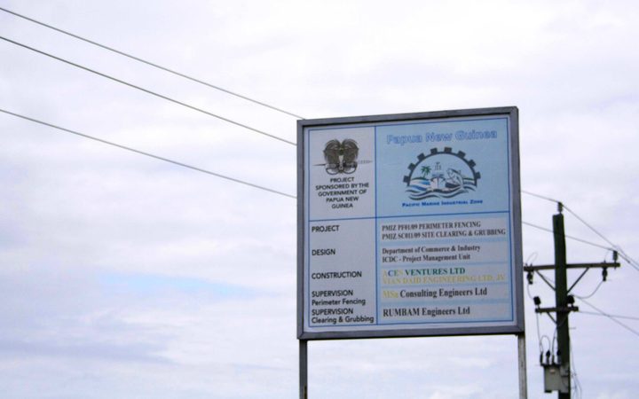 A sign on the perimeter fencing for the  Pacific Marine Industrial Zone (PMIZ) project in Madang, one of the few structures built from almost ten million US dollars spent on the project by Papua New Guinea's government in the past decade.