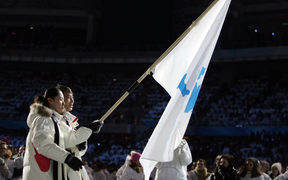 South Korea speed skater Bora Lee joined with Democratic People's Republic of Korea's figure skater Han Jong-In enter the Stadio Olimpico as they lead their delegation during the opening ceremony of the 2006 Winter Olympics. 