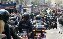 Crowds watch Boobs on Bikes' parade of topless women down Queen Street in 2006.
