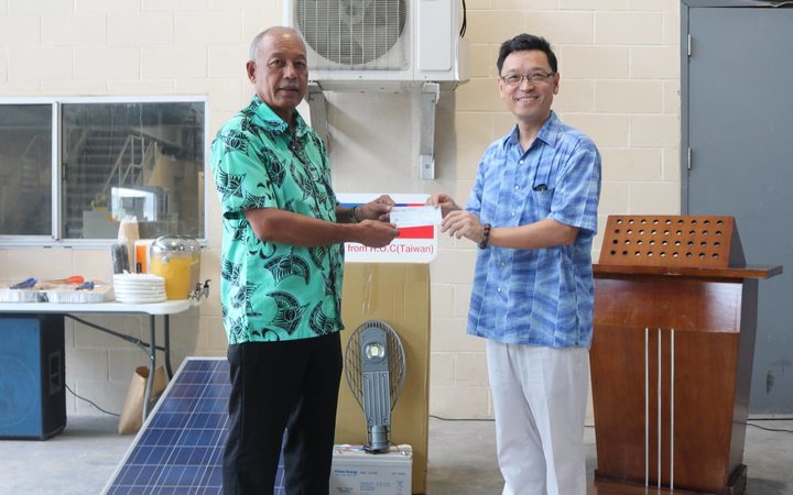 The Minister of Natural Resources and Commerce Dennis Momotaro (left) receives solar streetlight and funding donation from Taiwan's Ambassador to the Marshall Islands, Daniel Tang.