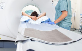 A woman goes through a CT scan.