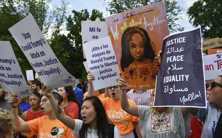 People protesting against the Muslim travel ban outside the US Supreme Court in Washington, DC, 26 June 2018.