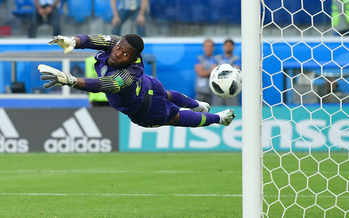 5560743 26.06.2018 Nigeria's goalkeeper Francis Uzoho jumps to make a save on a free kick by Argentina's Lionel Messi during the World Cup Group D soccer match between Nigeria and Argentina at the Saint Petersburg Stadium, in Saint Petersburg, Russia, June 26, 2018. Vladimir Pesnya / Sputnik