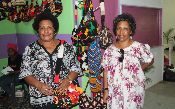 Two PNG women at the market selling their bilum bags