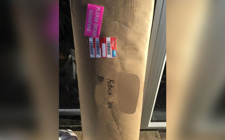 A PBT Couriers driver left this package, with a gun inside, leaning next to the front door because no one was home.