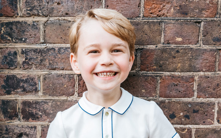 A handout picture released by Kensington Palace to mark Prince George's fifth birthday shows him smiling to camera. 