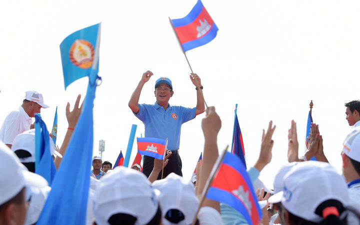 Cambodia's Prime Minister Hun Sen and leader of the ruling Cambodian People's Party (CPP) waves to supporters.