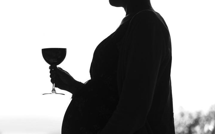 Generic pregnant woman drinking alcohol.
