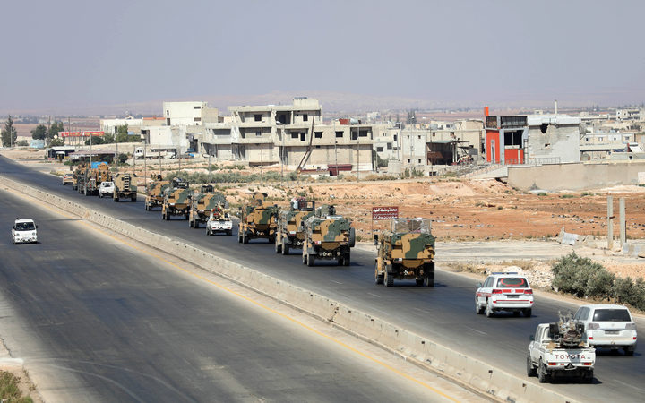 Turkish forces are seen in a convoy on a main highway between Damascus and Aleppo, near the town of Saraqib in the northern Idlib province.