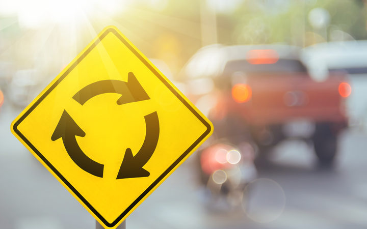 Stock photo of a roundabout sign.
