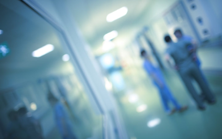 Health care workers in the hospital corridor.