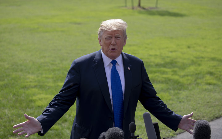 United States President Donald J. Trump speaks with members of the media prior to boarding Marine One for his departure from the White House on October 2, 2018 in Washington, DC. Photo Credit: Alex Edelman/CNP | usage worldwide