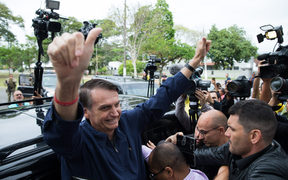 Brazil's right-wing presidential candidate for the Social Liberal Party (PSL) Jair Bolsonaro gives his thumbs up after casting his vote at Villa Militar, during general elections.