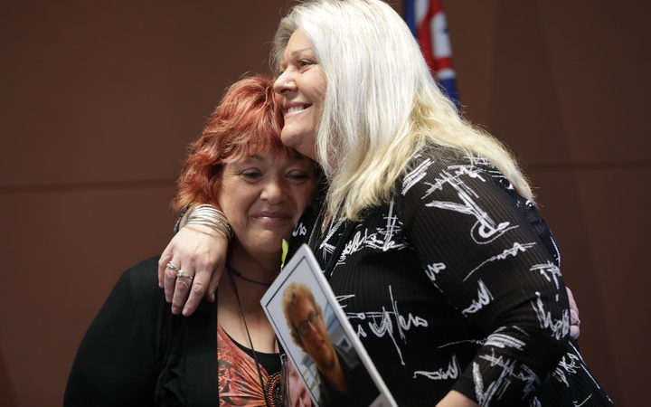 Relatives of mine victims Anna Osborne and Sonya Rockhouse embrace after the announcement of the re-entry plan.
