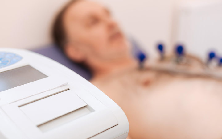 Magical machinery. Man making sure his heart is functioning without problems by examining it using special equipment