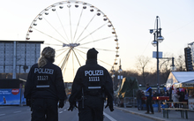 Police patrol at the fair grounds ahead of the New Year's Eve party near the Brandenburg Gate in Berlin.