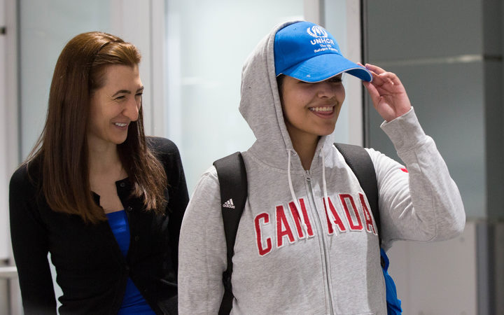Saudi teenager Rahaf Mohammed al-Qunun (R) arrives at Pearson International airport in Toronto, Ontario.