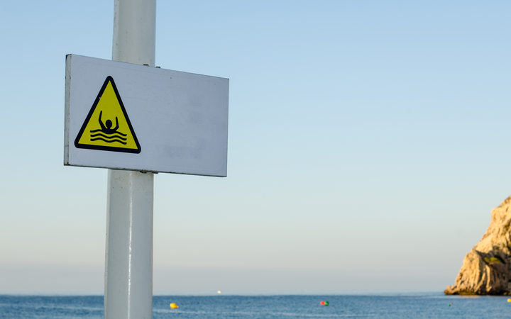 Sign on a beach resort warning of strong rip currents