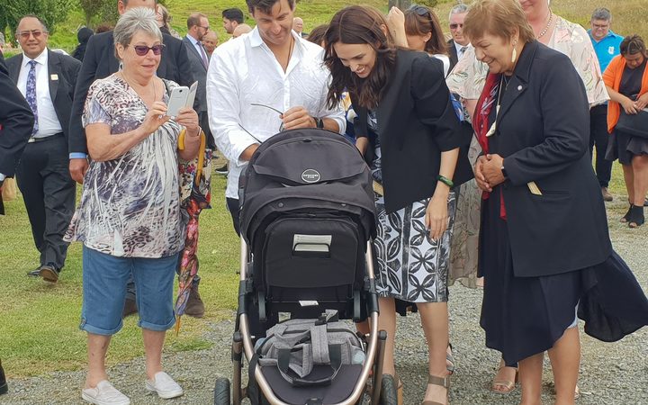 PM and partner Clarke Gayford check on baby Neve alongside members of Otematea Marae at Kaipara.