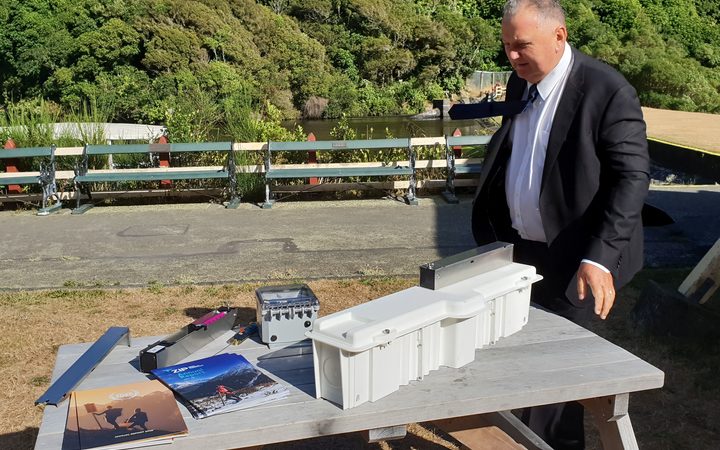 Regional Economic Development Minister Shane Jones inspects a new trap design.