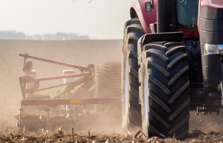 The tractor harvester working on the field