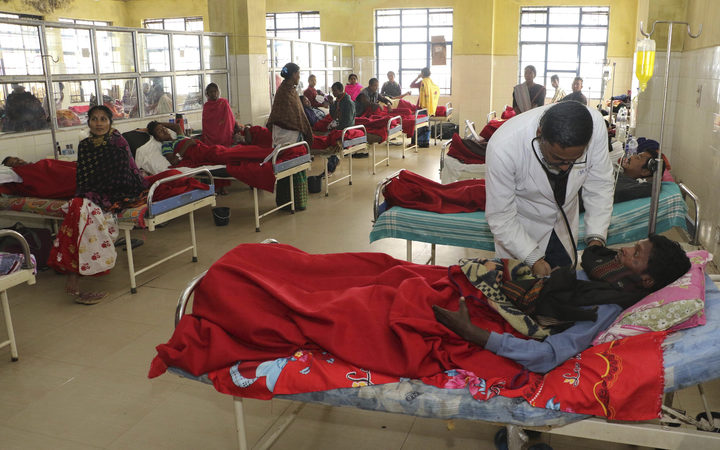 A doctor attends to a victim, who had consumed bootleg liquor, at a hospital in Jorhat in northeastern state of Assam, India, Saturday, Feb. 23, 2019. 