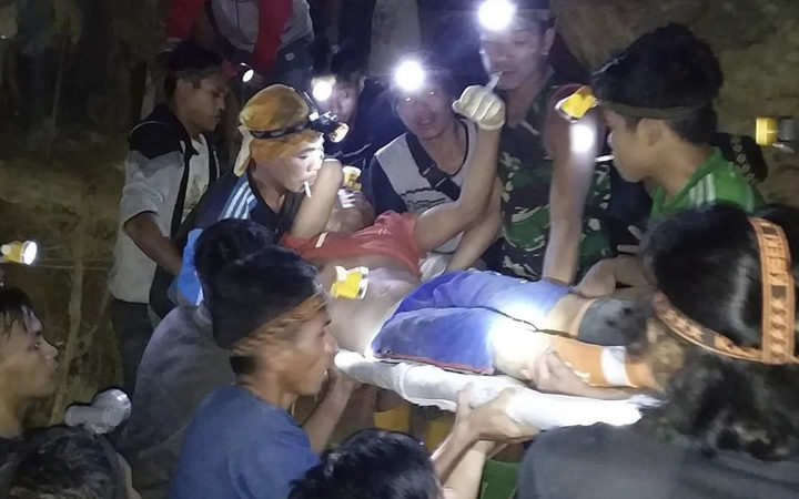 In this undated photo released by Indonesian Search And Rescue Agency (BASARNAS) rescuers evacuate a survivor from a collapsed gold mine in Bolaang Mongondow, North Sulawesi, Indonesia. 