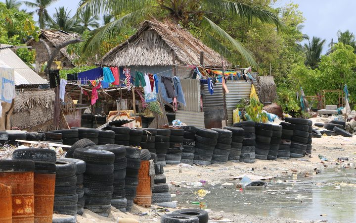 Villagers have resorted to using tires and barrels for protection from the sea 