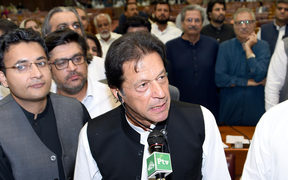 Pakistan's newly appointed Prime Minister Imran Khan (C) addresses lawmakers after being elected by National Assembly in Islamabad